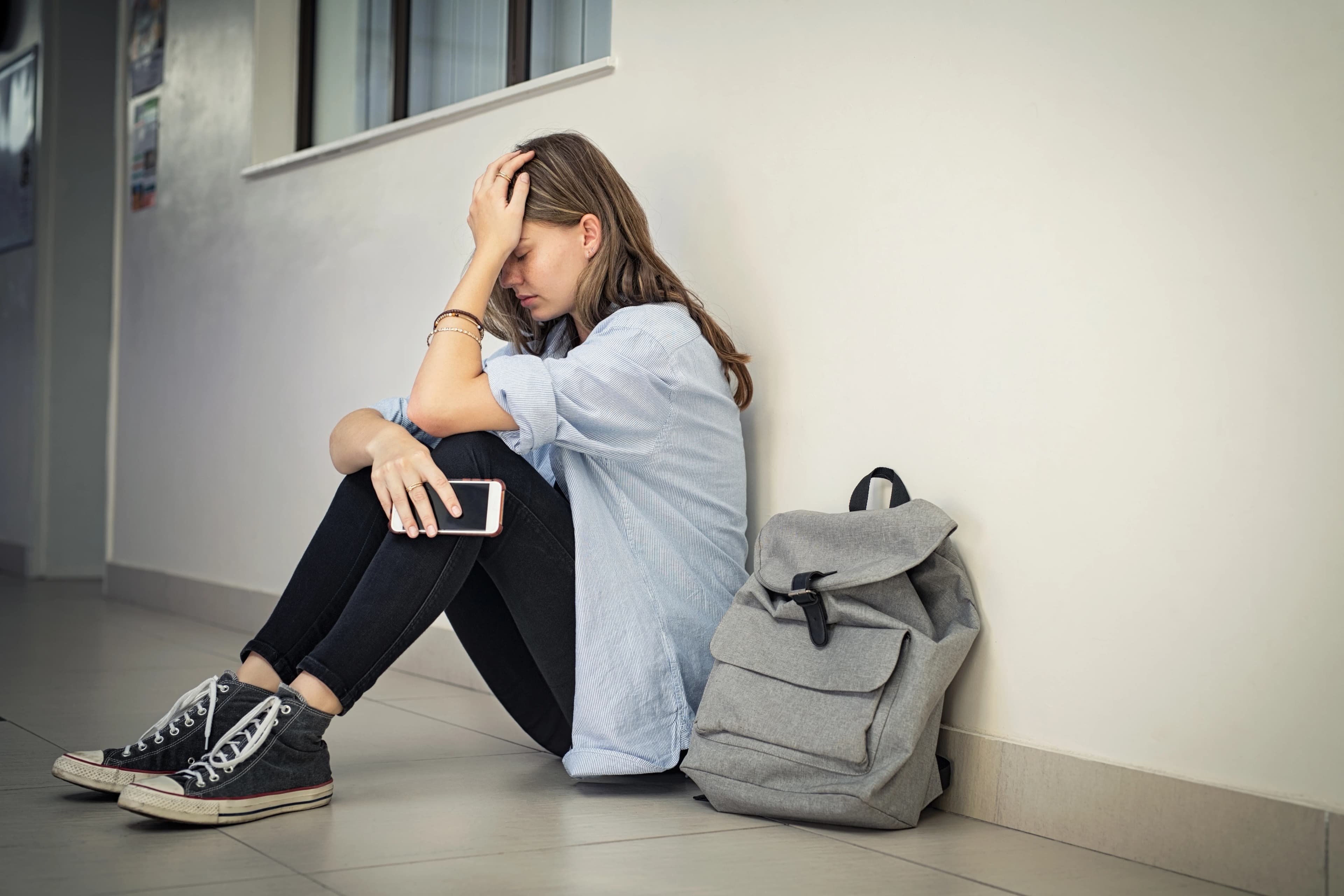 Worried young girl in the school hallway